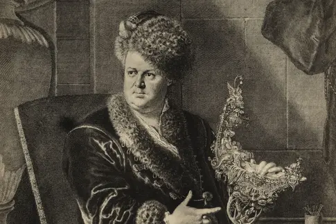 Abgebildet ist ein Kupferstich mit dem Portrait des Goldschmieds Johann Melchior Dinglinger. Er sitzt auf einem Stuhl und hält das Kunstwerk „Bad der Diana“ in der Hand.